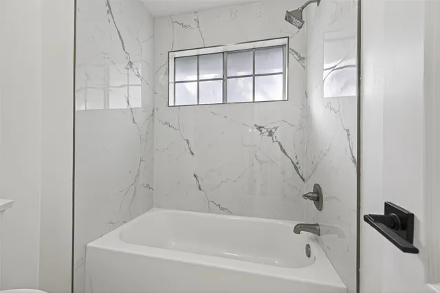 a bedroom with a large bed and a large window