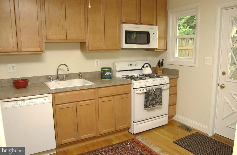 645 Coleraine Road Baltimore, MD 21229 - Photo 13 of 28 a kitchen with stainless steel appliances granite countertop a sink stove and microwave