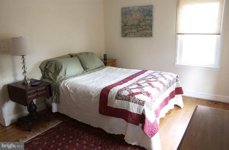 645 Coleraine Road Baltimore, MD 21229 - Photo 20 of 28 a bedroom with a bed and wooden floor