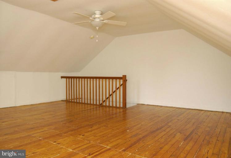645 Coleraine Road Baltimore, MD 21229 - Photo 26 of 28 an empty room with wooden floor and fan