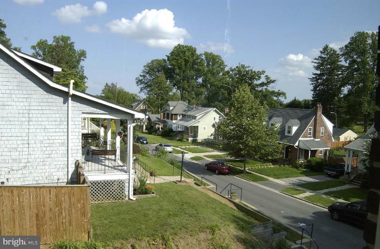645 Coleraine Road Baltimore, MD 21229 - Photo 27 of 28 a front view of a house with a yard table and chairs
