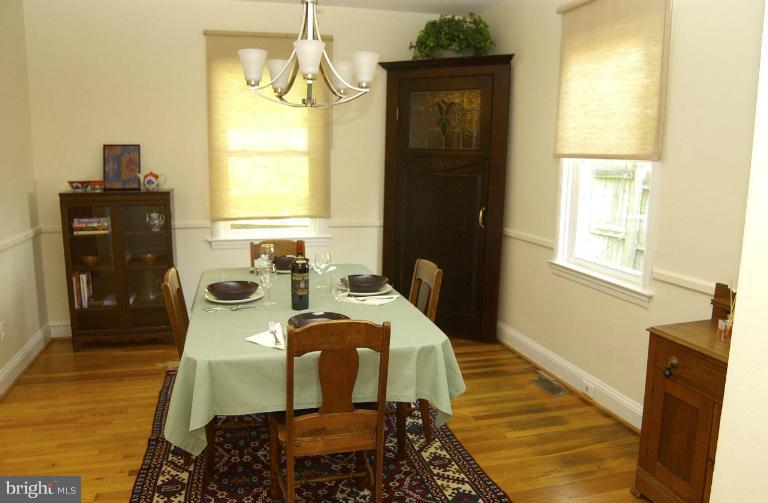 645 Coleraine Road Baltimore, MD 21229 - Photo 5 of 28 a bedroom with a bed and wooden floor