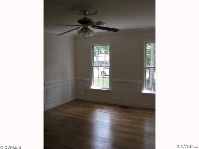 6002 Sedgefield Road Midlothian, VA 23112 - Photo 3 of 12 a view of an empty room with wooden floor and a window