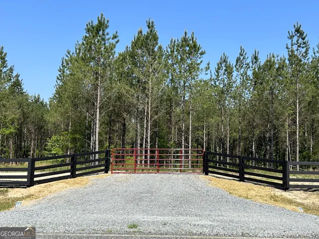 a view of a park with iron fence