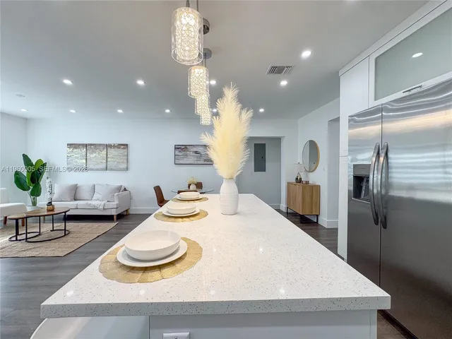 a kitchen with sink and refrigerator