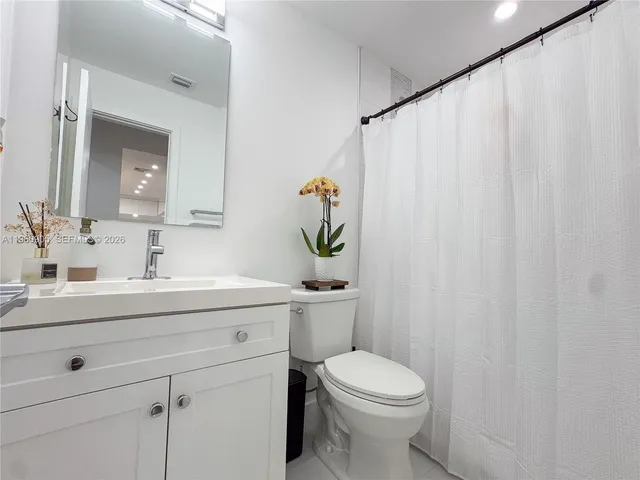 a bathroom with a sink a mirror and a toilet