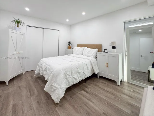 a bedroom with a bed and a mirror