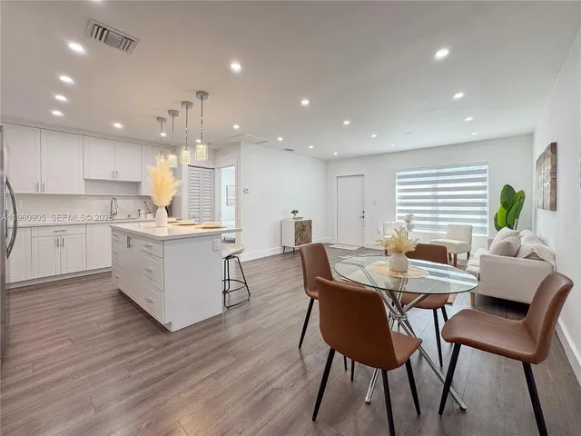 a view of a dining room with furniture and wooden floor