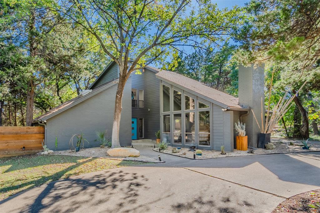 a front view of a house with a tree