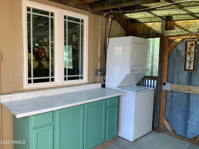 a view of porch with a table and chairs