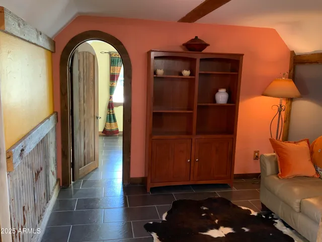 a blue bed sitting in a bedroom next to a lamp