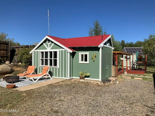 a view of a house with swimming pool and sitting area