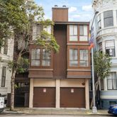 a front view of a residential apartment building with a yard