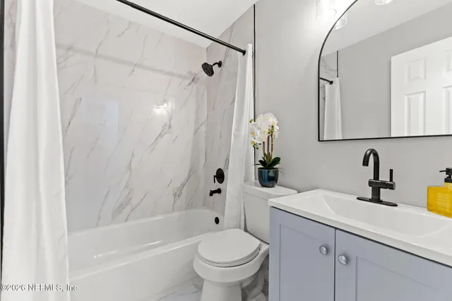 a bathroom with a sink a toilet and a bathtub