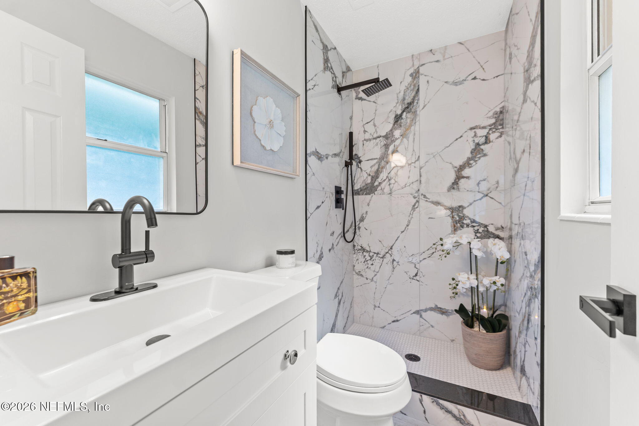 2455 Seaway Street Jacksonville, FL 32233 - Photo 10 of 16 a bathroom with a sink toilet vanity and shower