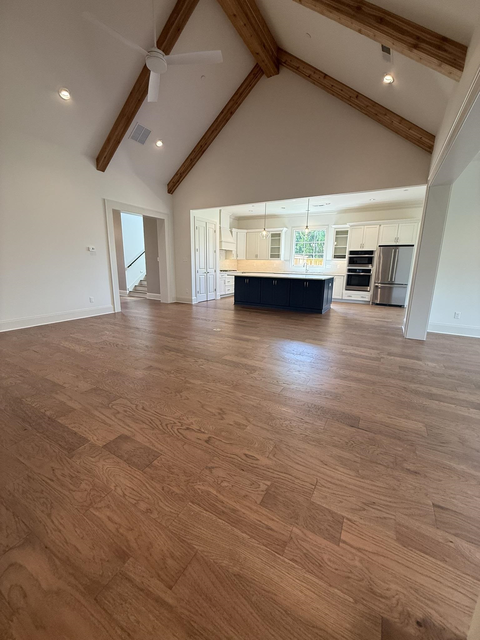 10132 Rokeby Farm Lane Collierville, TN 38017 - Photo 6 of 24 Open-concept living area featuring wood-finish flooring, a vaulted ceiling with exposed wooden beams, and recessed lighting