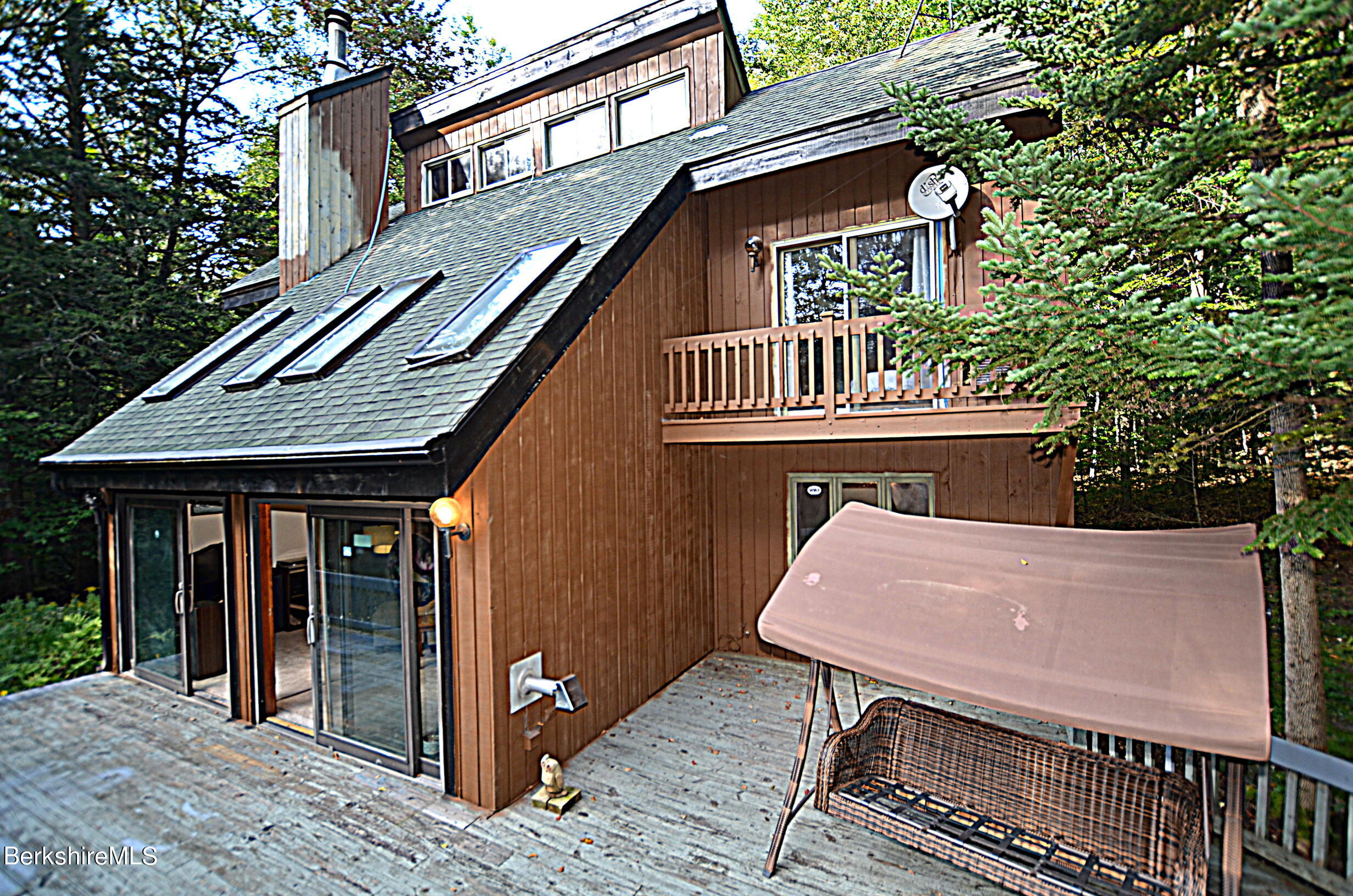 2477 West Center Road Otis, MA 01253 - Photo 1 of 31 a roof deck with table and chairs