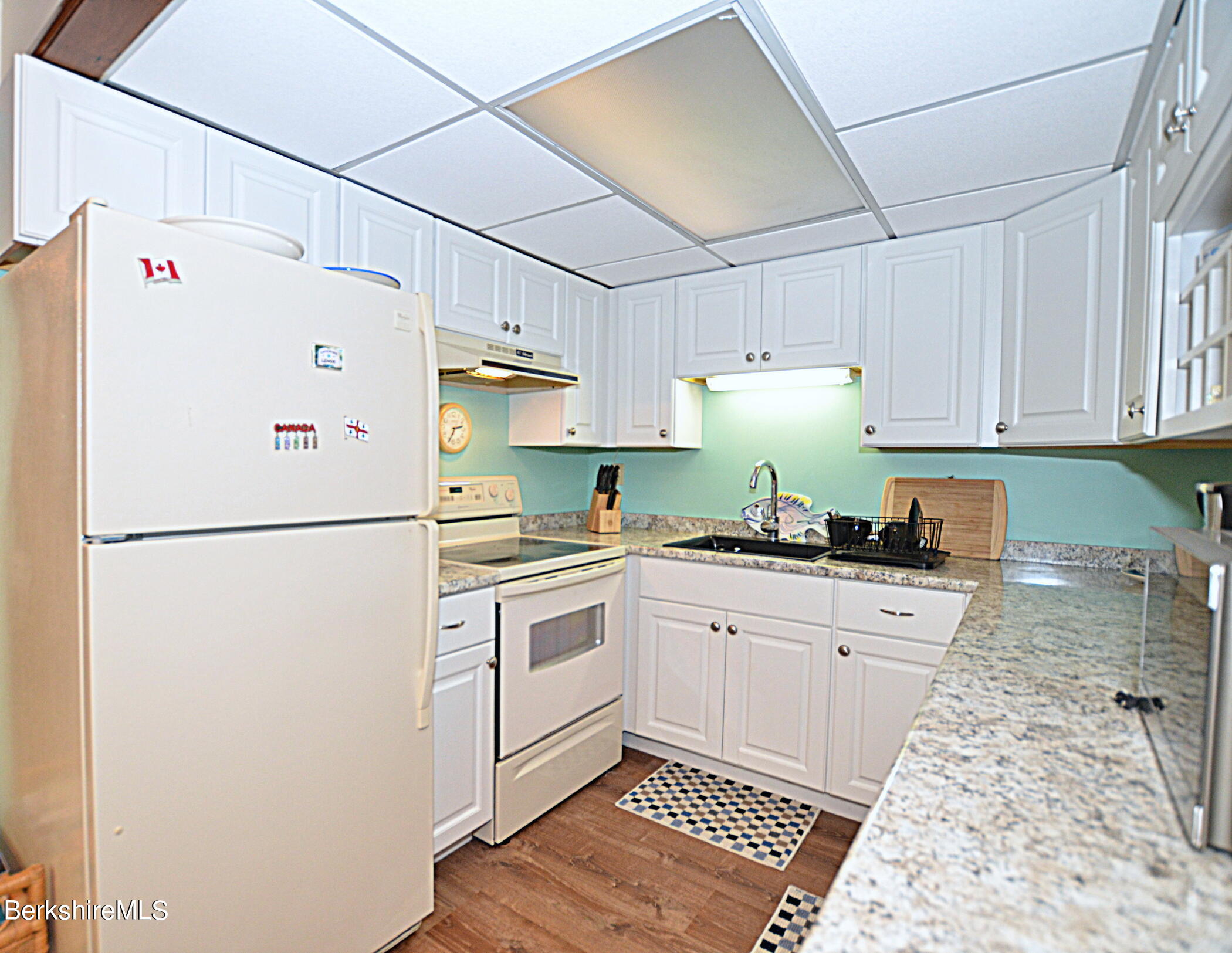 2477 West Center Road Otis, MA 01253 - Photo 11 of 31 a white refrigerator freezer sitting inside of a kitchen