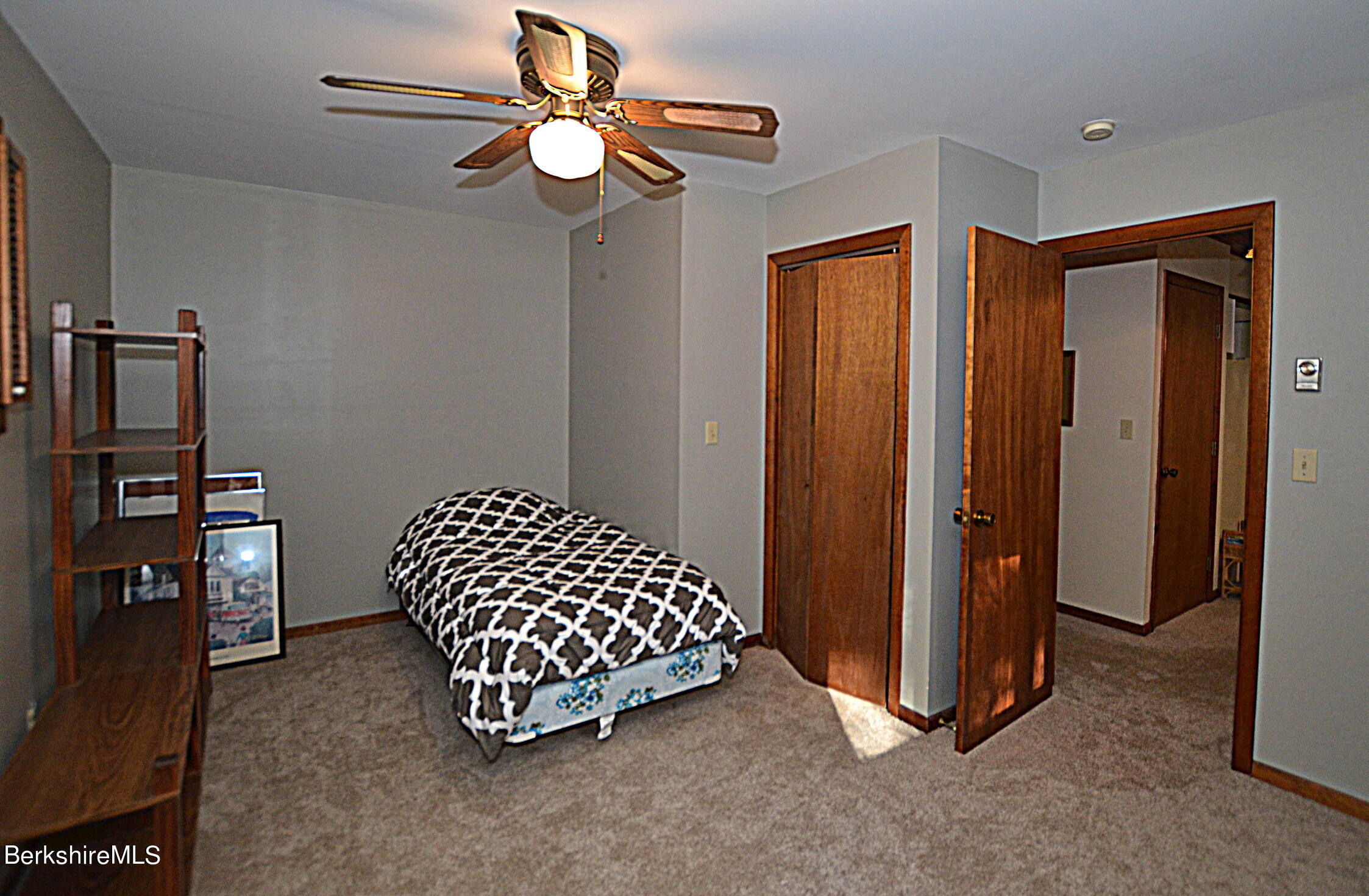 2477 West Center Road Otis, MA 01253 - Photo 15 of 31 a spacious bedroom with a bed and a chandelier