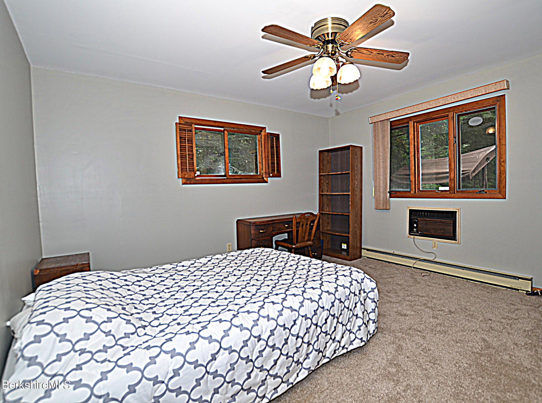 2477 West Center Road Otis, MA 01253 - Photo 17 of 31 a bedroom with a bed and a chandelier