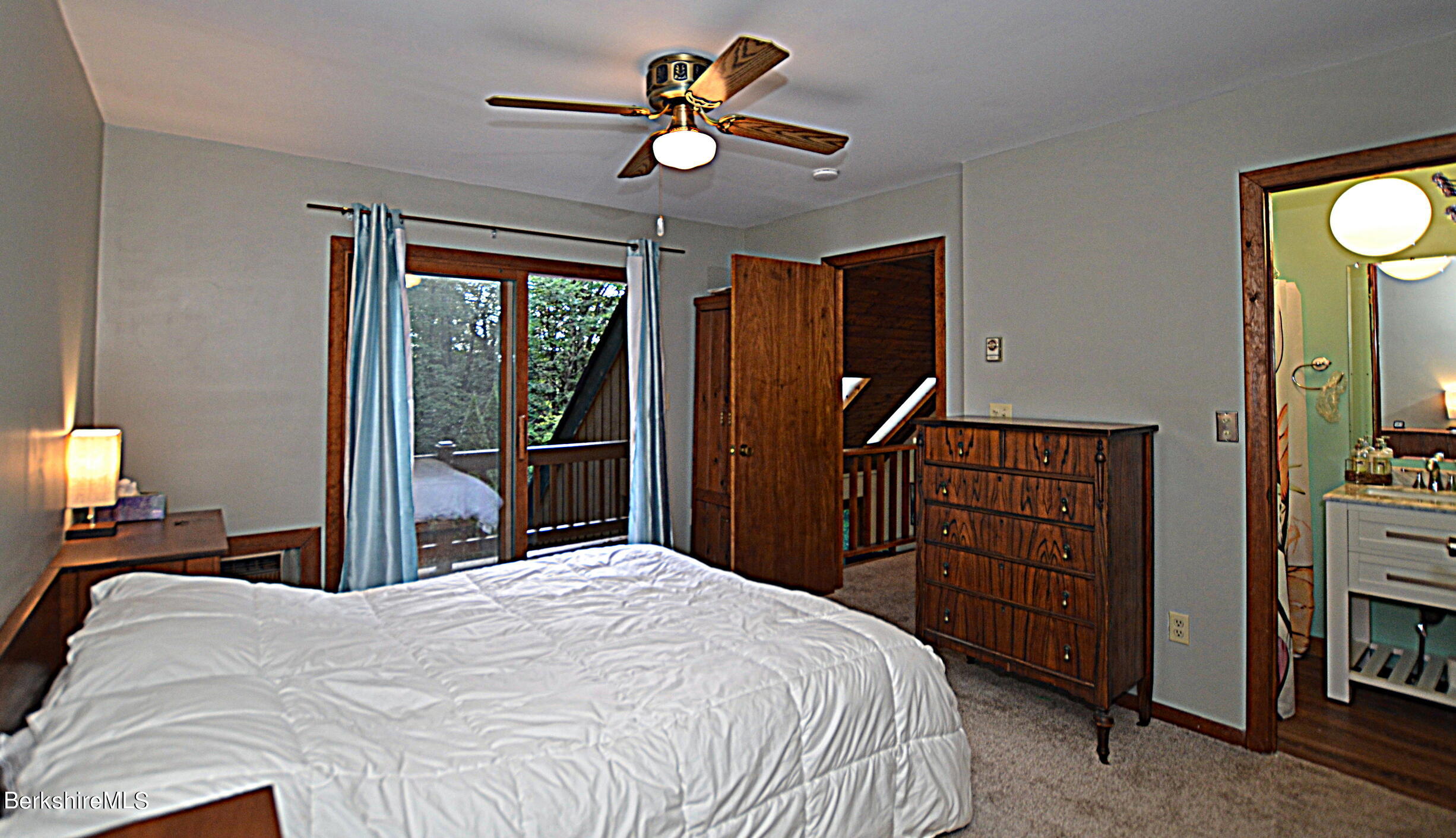 2477 West Center Road Otis, MA 01253 - Photo 23 of 31 a bedroom with a bed and a chandelier