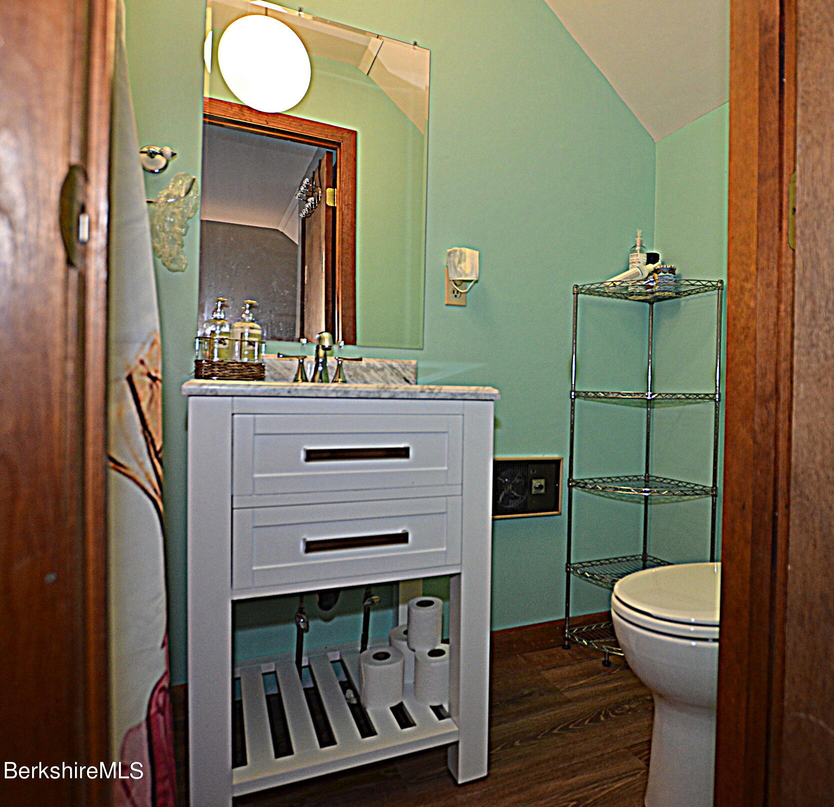 2477 West Center Road Otis, MA 01253 - Photo 25 of 31 a bathroom with a sink a toilet and mirror