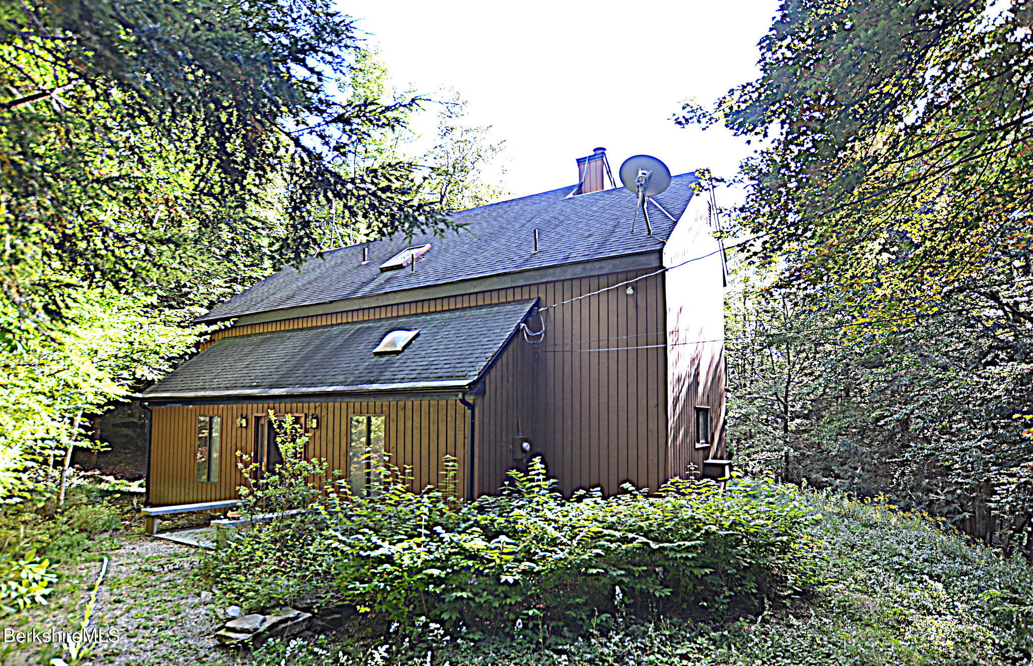 2477 West Center Road Otis, MA 01253 - Photo 3 of 31 a front view of a house with garden