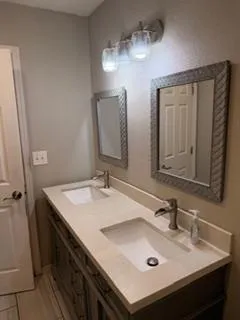 a bathroom with a sink vanity and a mirror
