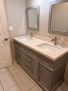 a bathroom with a sink vanity and a mirror