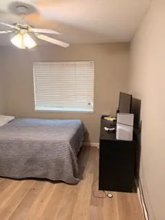 a bedroom with a bed and window