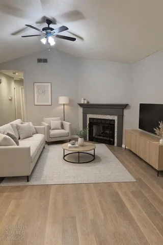 a living room with furniture and a fireplace