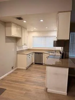 a kitchen with a stove top oven sink and cabinets
