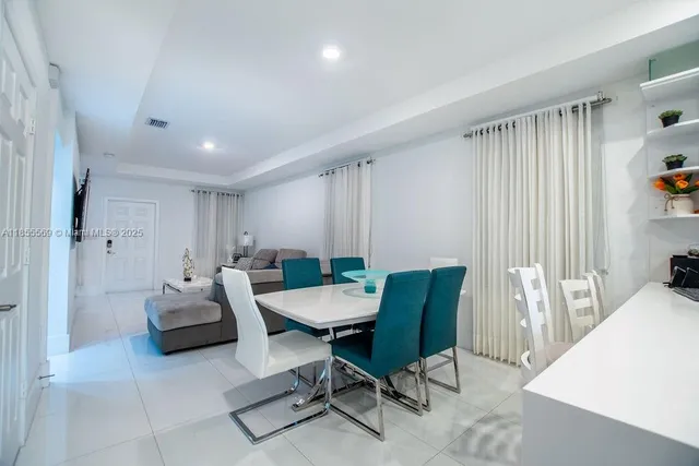 a kitchen with sink a counter and chairs