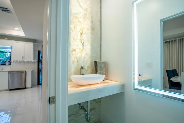 a white toilet sitting next to a bathroom sink