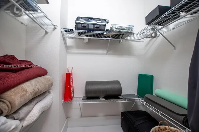 a bathroom with a granite countertop sink a mirror and a shower