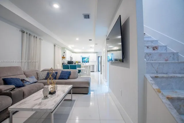 a kitchen with granite countertop white cabinets and stainless steel appliances