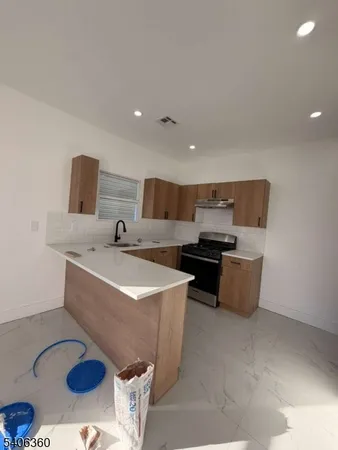 a kitchen with a sink a stove and refrigerator