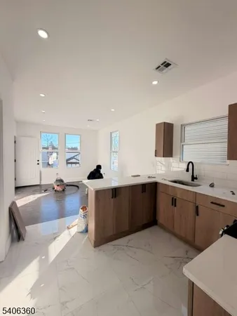 a large kitchen with lots of counter space and windows