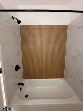 a bathroom with a shower and a bathtub