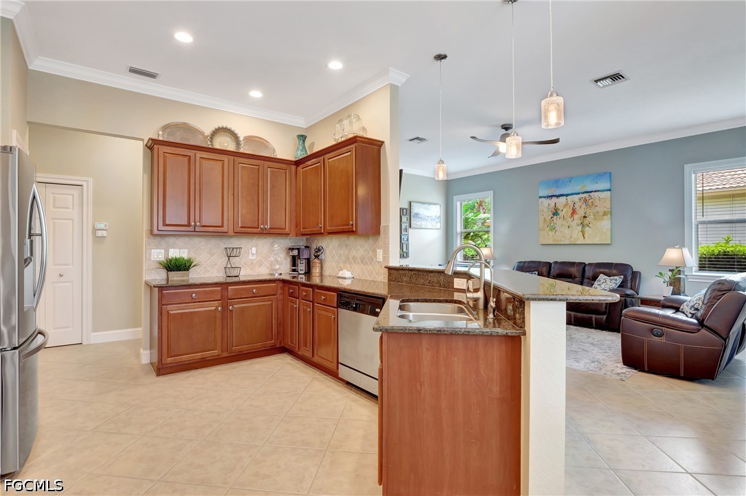 11230 Suffield Street Fort Myers, FL 33913 - Photo 13 of 42 a kitchen with stainless steel appliances granite countertop a stove sink and cabinets