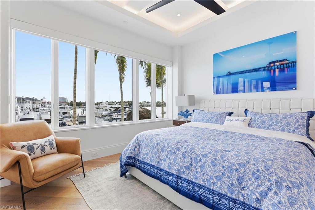 909 10th Street South, Unit 201 Naples, FL 34102 - Photo 12 of 42 Bedroom featuring wood finished floors and ceiling fan
