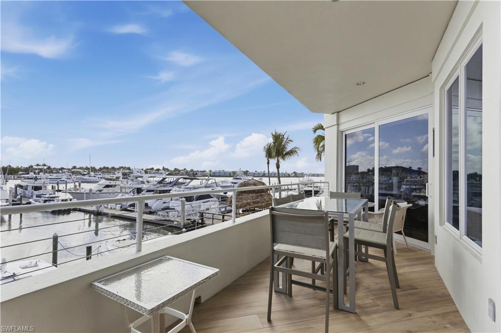 909 10th Street South, Unit 201 Naples, FL 34102 - Photo 15 of 42 Balcony with a water view and view of marina