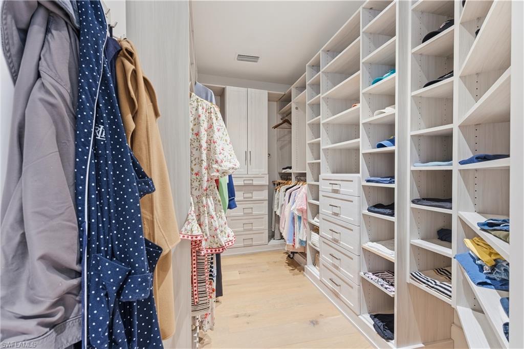 909 10th Street South, Unit 201 Naples, FL 34102 - Photo 20 of 42 Walk in closet featuring light wood-style floors