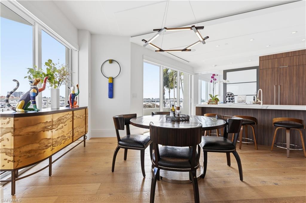 909 10th Street South, Unit 201 Naples, FL 34102 - Photo 25 of 42 Dining space with light wood-type flooring and hanging lights