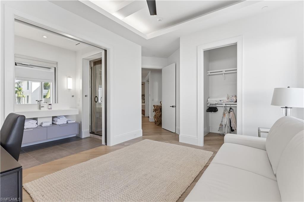 909 10th Street South, Unit 201 Naples, FL 34102 - Photo 31 of 42 Bedroom featuring light wood-style flooring, a closet, a ceiling fan, and recessed lighting