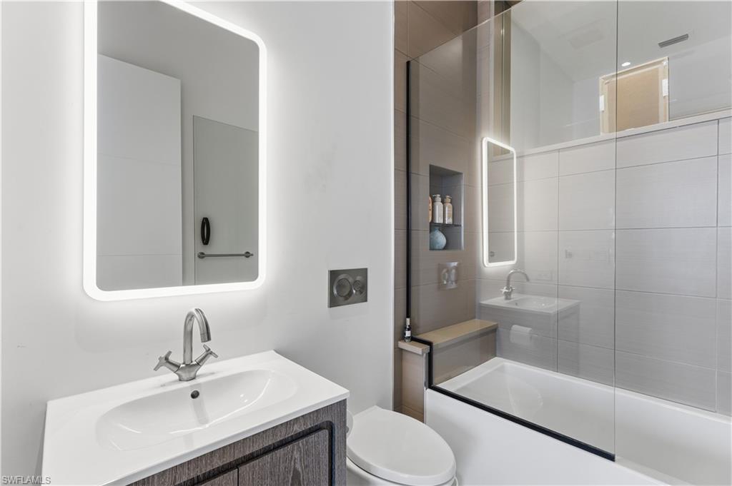 909 10th Street South, Unit 201 Naples, FL 34102 - Photo 35 of 42 Bathroom with vanity and combined bath / shower with glass door