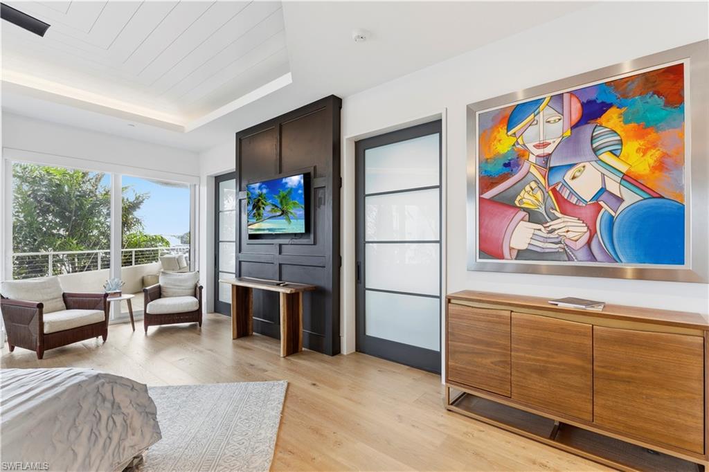 909 10th Street South, Unit 201 Naples, FL 34102 - Photo 38 of 42 Bedroom with light wood finished floors