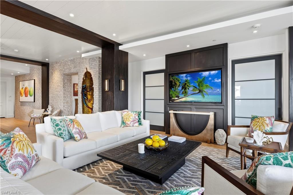 909 10th Street South, Unit 201 Naples, FL 34102 - Photo 4 of 42 Living area with brick wall, light wood-style flooring, recessed lighting, and beam ceiling