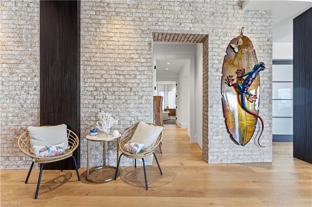 909 10th Street South, Unit 201 Naples, FL 34102 - Photo 8 of 42 Corridor with light wood-style floors