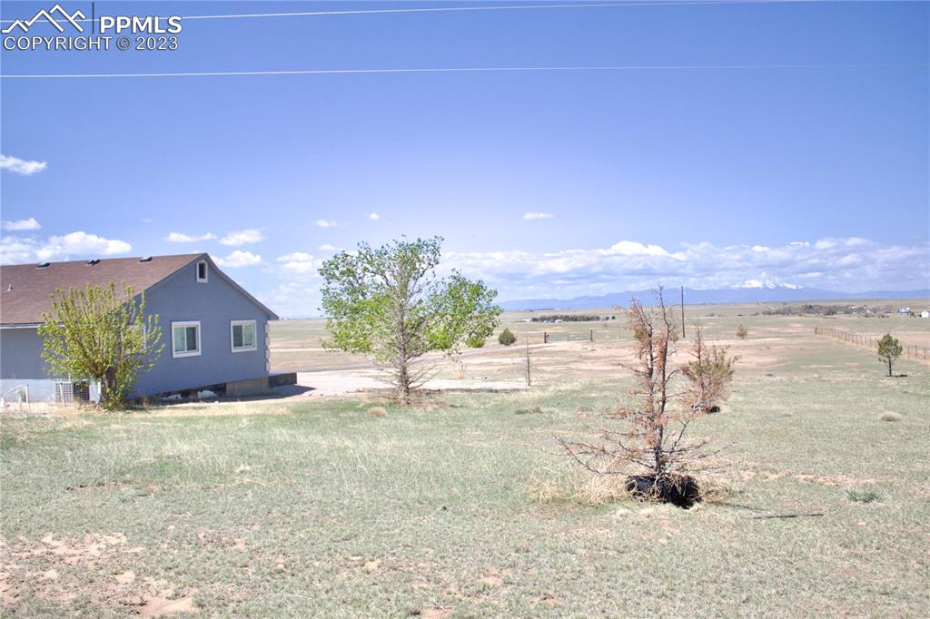 425 Weissenfluh Road Yoder, CO 80864 - Photo 12 of 38 a view of a house with a yard